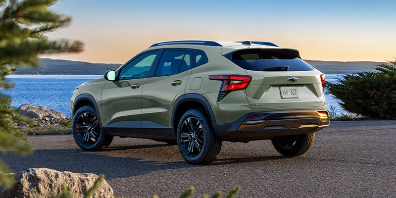 Back view of Chevy Trax parked on road besides the lake