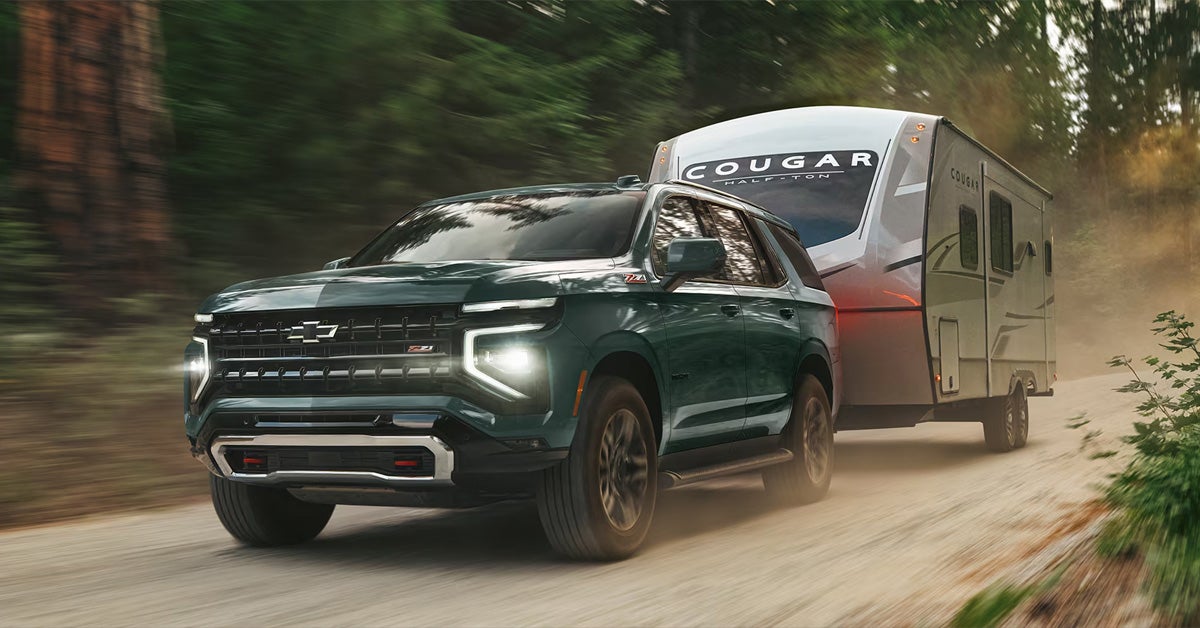 2026 Chevrolet Tahoe towing a trailer on the road