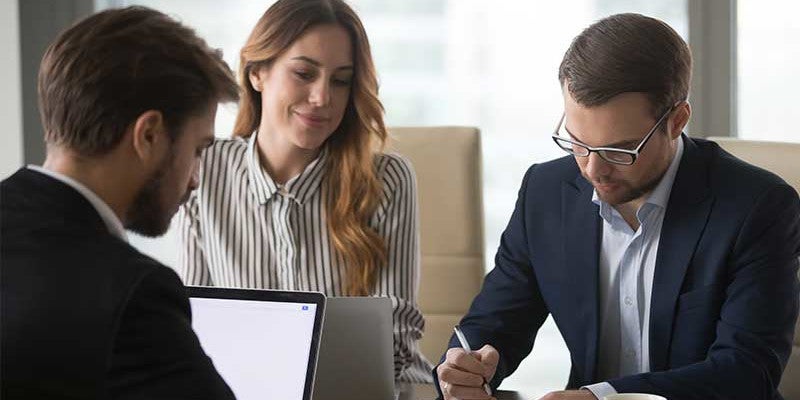 Couple at desk signing paperwork