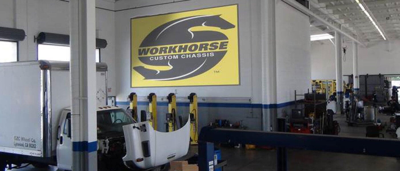 A truck with its hood up inside repaid shop of Penske RV & Truck Service Center