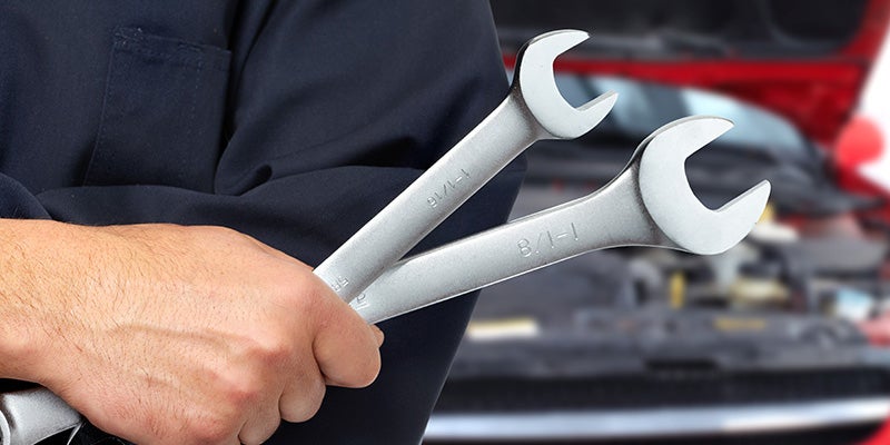 Mechanic holding two wrenches 