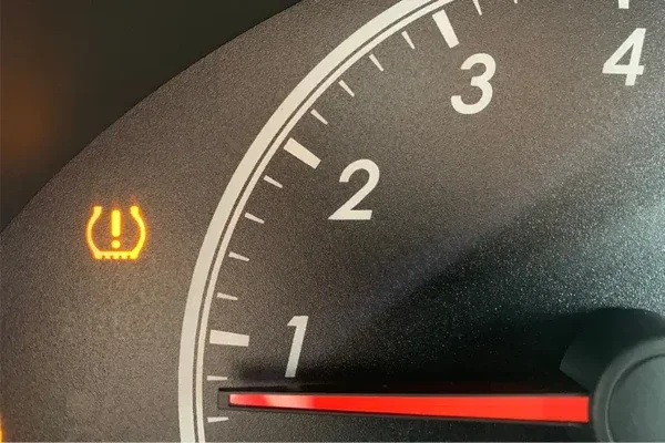Low tire pressure indicator light on a car dashboard