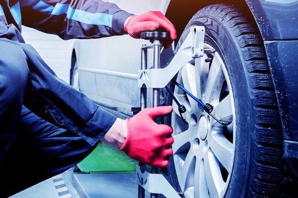 Mechanic performing a tire alignment